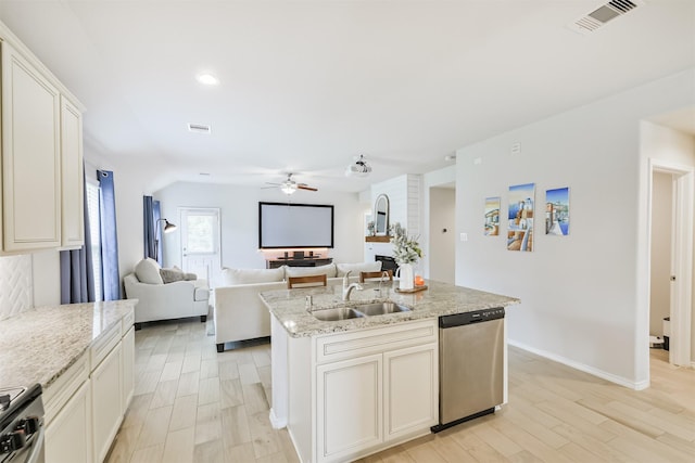 24218 Birchwood Creek Ct, Spring, TX 77389 - kitchen with stainless steel appliances, ceiling fan, light wood finished floors, an island with sink, and light stone counters