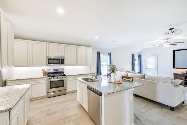 24218 Birchwood Creek Ct, Spring, TX 77389 - kitchen featuring appliances with stainless steel finishes, healthy amount of natural light, decorative backsplash, recessed lighting, and ceiling fan