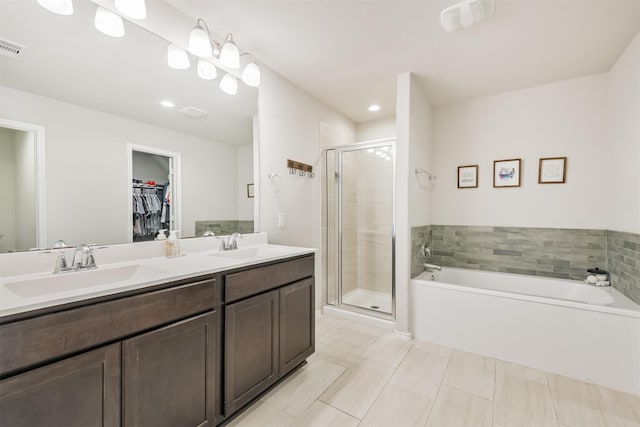 24218 Birchwood Creek Ct, Spring, TX 77389 - bathroom with a bath, a shower stall, a spacious closet, double vanity, and recessed lighting