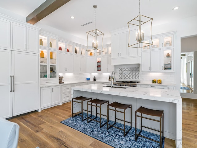 518 Hallie Dr, Houston, TX 77024 - kitchen with a chandelier, white cabinets, a kitchen breakfast bar, hanging light fixtures, and beamed ceiling