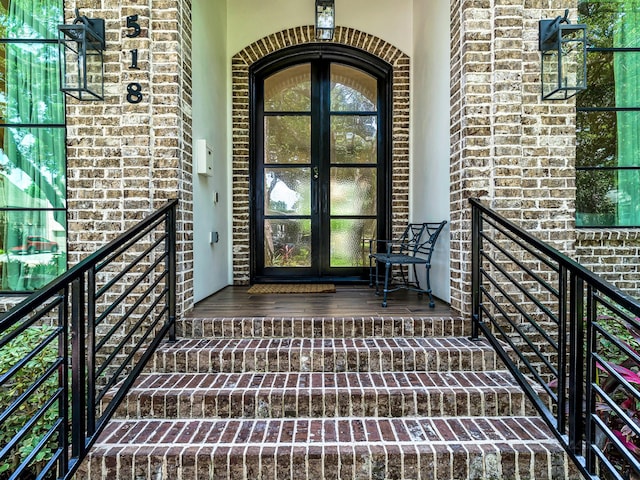 518 Hallie Dr, Houston, TX 77024 - doorway to property with french doors, brick siding, stone siding, and stucco siding