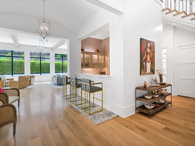 518 Hallie Dr, Houston, TX 77024 - foyer entrance with a chandelier, wood finished floors, and vaulted ceiling