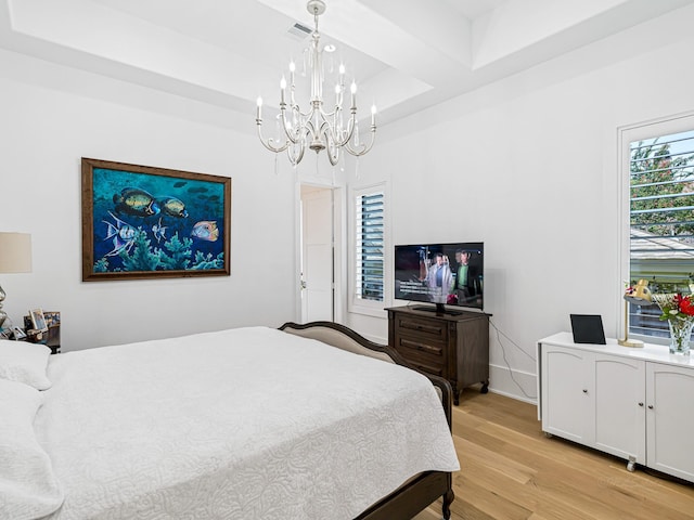 518 Hallie Dr, Houston, TX 77024 - bedroom with a chandelier, light wood-style floors, and a raised ceiling