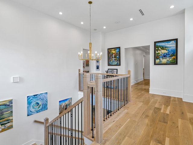 518 Hallie Dr, Houston, TX 77024 - hall featuring an upstairs landing, a chandelier, light wood finished floors, and recessed lighting