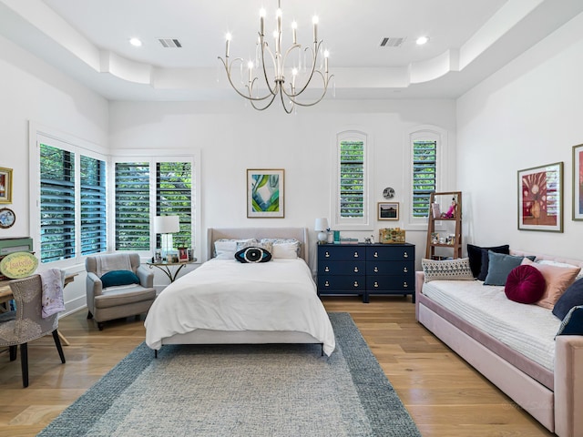 518 Hallie Dr, Houston, TX 77024 - bedroom featuring a tray ceiling, a chandelier, multiple windows, light wood finished floors, and recessed lighting
