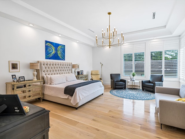 518 Hallie Dr, Houston, TX 77024 - bedroom with a chandelier, light wood-style floors, a raised ceiling, and recessed lighting