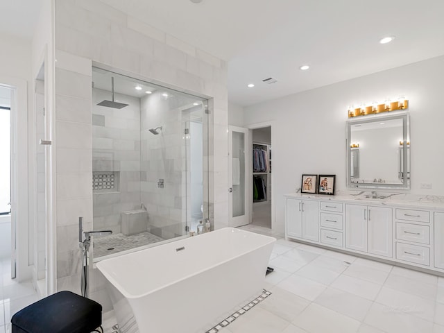 518 Hallie Dr, Houston, TX 77024 - bathroom with a tile shower, a freestanding tub, vanity, a spacious closet, and recessed lighting