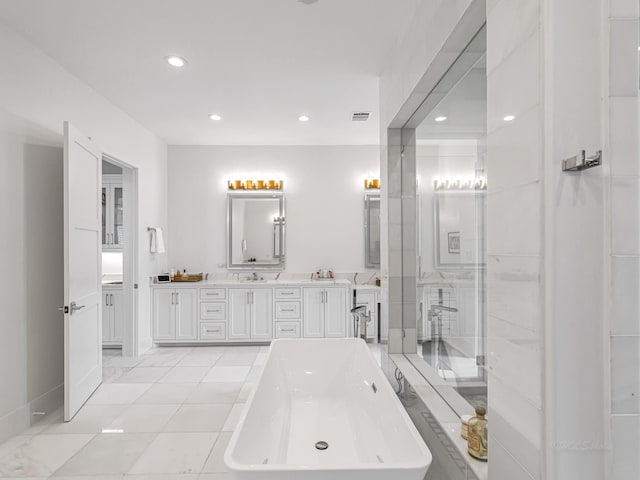 518 Hallie Dr, Houston, TX 77024 - full bathroom with a freestanding bath, double vanity, recessed lighting, and tile patterned flooring