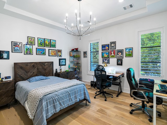 518 Hallie Dr, Houston, TX 77024 - bedroom with a raised ceiling, a chandelier, light wood-type flooring, and an office area
