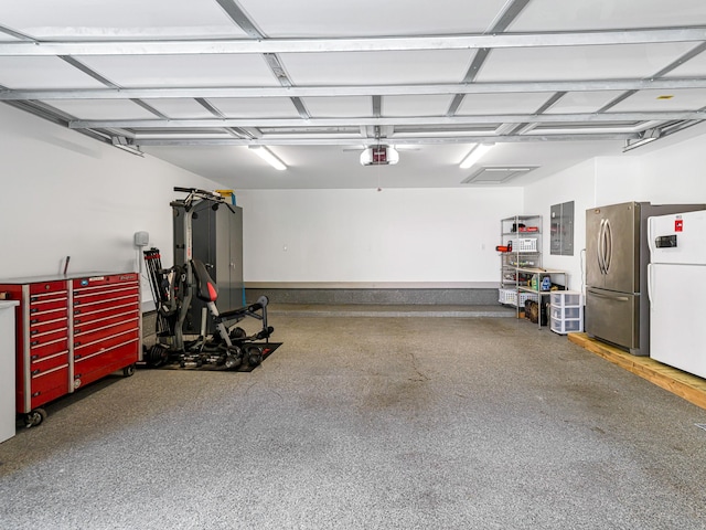 518 Hallie Dr, Houston, TX 77024 - garage with electric panel, a garage door opener, and freestanding refrigerator