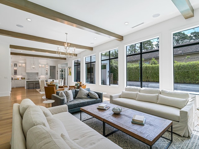 518 Hallie Dr, Houston, TX 77024 - living area featuring a chandelier, beam ceiling, light wood finished floors, and recessed lighting