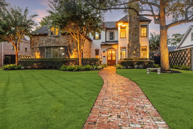 7614 Brykerwoods Dr, Houston, TX 77055 - view of front of house featuring stone siding, a front yard, french doors, and stucco siding
