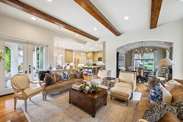 7614 Brykerwoods Dr, Houston, TX 77055 - living area featuring a chandelier, recessed lighting, light wood-style flooring, arched walkways, and beam ceiling