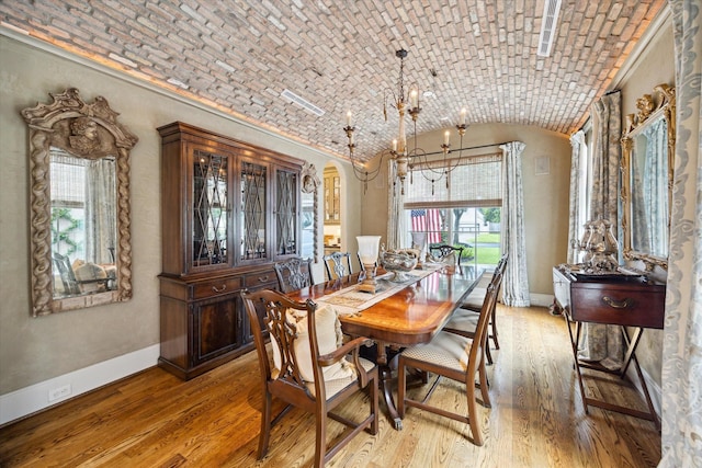 7614 Brykerwoods Dr, Houston, TX 77055 - dining room with vaulted ceiling, light wood-type flooring, brick ceiling, a chandelier, and crown molding
