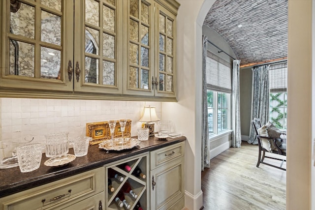 7614 Brykerwoods Dr, Houston, TX 77055 - indoor dry bar with tasteful backsplash, arched walkways, light wood-style flooring, brick ceiling, and vaulted ceiling