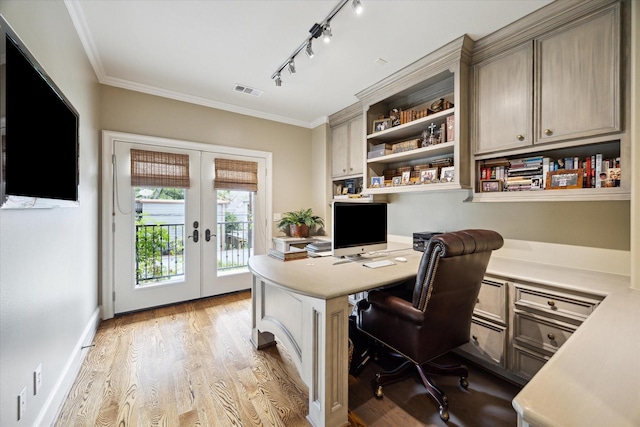 7614 Brykerwoods Dr, Houston, TX 77055 - office featuring french doors, ornamental molding, light wood-style flooring, built in desk, and track lighting
