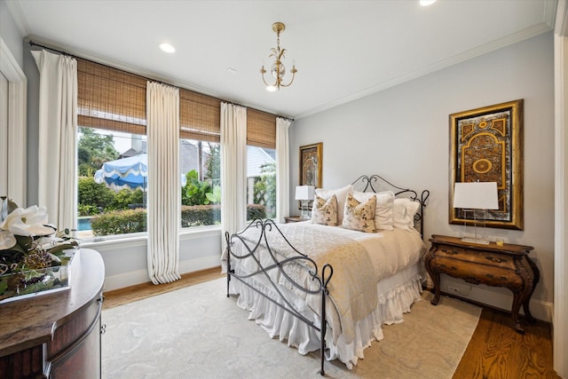 7614 Brykerwoods Dr, Houston, TX 77055 - bedroom featuring crown molding, light wood-type flooring, a chandelier, and recessed lighting