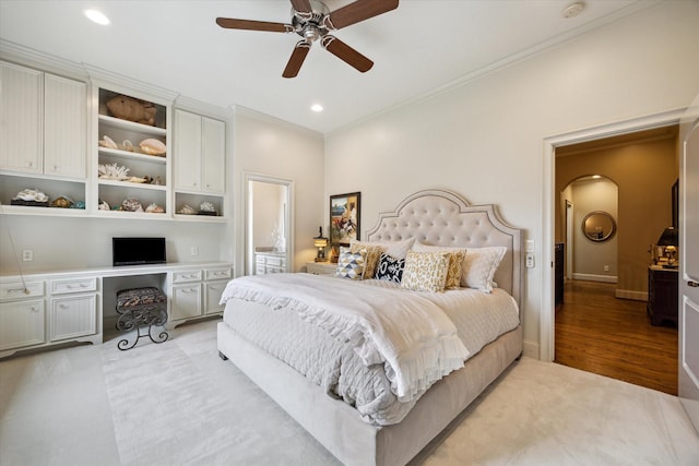7614 Brykerwoods Dr, Houston, TX 77055 - bedroom featuring ornamental molding, arched walkways, recessed lighting, light wood-type flooring, and built in desk