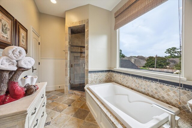 7614 Brykerwoods Dr, Houston, TX 77055 - full bath featuring a stall shower, a bath, vanity, wainscoting, and stone finish floors