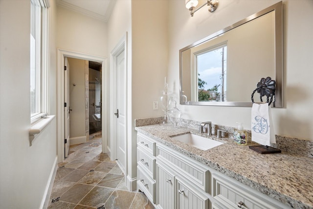 7614 Brykerwoods Dr, Houston, TX 77055 - bathroom featuring ornamental molding, vanity, and stone finish floors