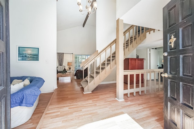 7642 Candlegreen Ln, Houston, TX 77071 - entrance foyer featuring high vaulted ceiling, stairs, light wood finished floors, and a chandelier