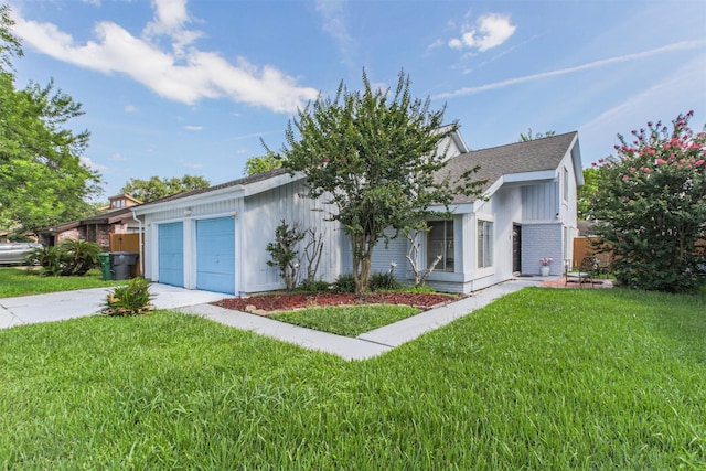7642 Candlegreen Ln, Houston, TX 77071 - view of front of house with an attached garage, a front lawn, concrete driveway, and board and batten siding