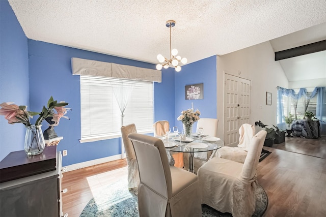 7642 Candlegreen Ln, Houston, TX 77071 - dining space with wood finished floors, a textured ceiling, a chandelier, plenty of natural light, and vaulted ceiling