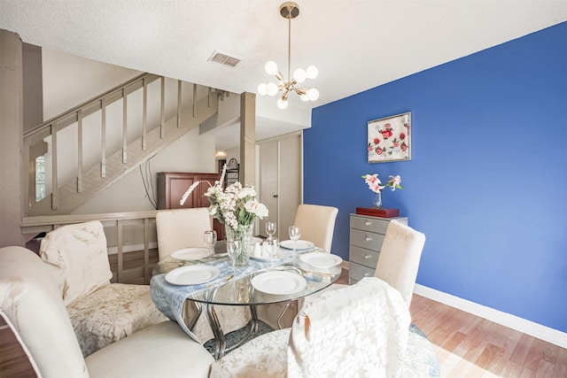 7642 Candlegreen Ln, Houston, TX 77071 - dining space with wood finished floors and a chandelier