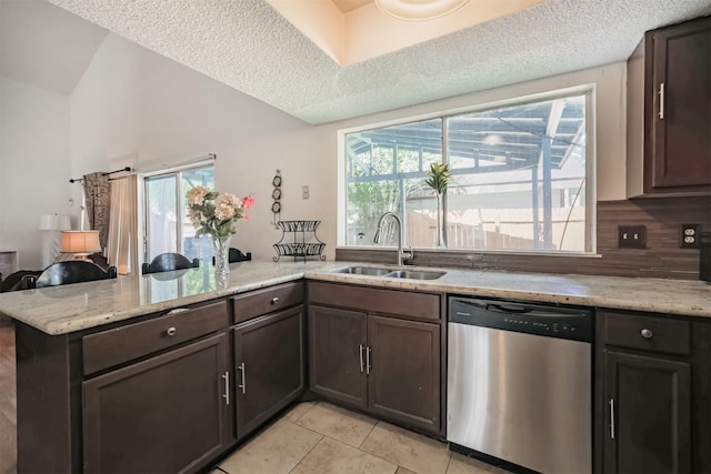 7642 Candlegreen Ln, Houston, TX 77071 - kitchen featuring dishwasher, a peninsula, light tile patterned flooring, plenty of natural light, and lofted ceiling