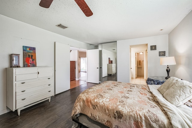 7642 Candlegreen Ln, Houston, TX 77071 - bedroom featuring wood finished floors, connected bathroom, and ceiling fan