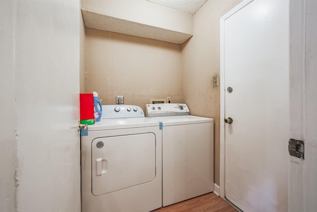 7642 Candlegreen Ln, Houston, TX 77071 - washroom featuring separate washer and dryer and light wood-style floors