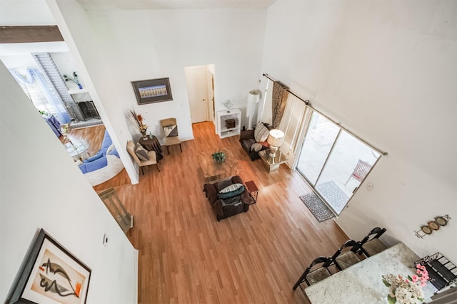 7642 Candlegreen Ln, Houston, TX 77071 - living room featuring a high ceiling, wood finished floors, a fireplace, and heating unit