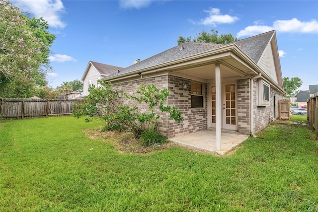 1714 Regal Blue Ct, Fresno, TX 77545 - back of property with a fenced backyard, a patio, a shingled roof, and brick siding