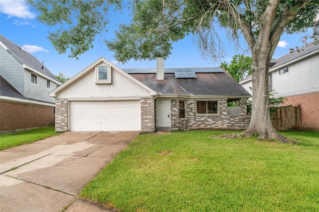 1714 Regal Blue Ct, Fresno, TX 77545 - traditional-style home featuring brick siding, a chimney, concrete driveway, solar panels, and a garage