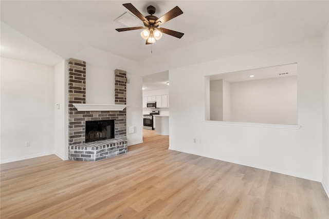 1714 Regal Blue Ct, Fresno, TX 77545 - unfurnished living room featuring ceiling fan, light wood finished floors, and a brick fireplace