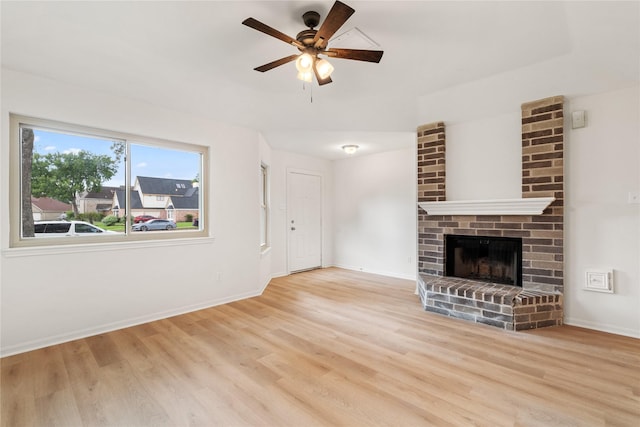 1714 Regal Blue Ct, Fresno, TX 77545 - unfurnished living room featuring light wood-type flooring, ceiling fan, and a fireplace