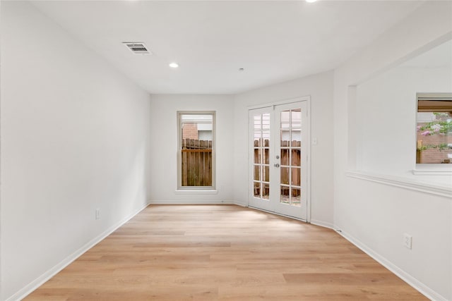 1714 Regal Blue Ct, Fresno, TX 77545 - unfurnished room featuring plenty of natural light, recessed lighting, french doors, and light wood-type flooring