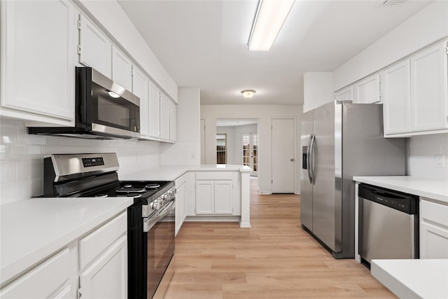 1714 Regal Blue Ct, Fresno, TX 77545 - kitchen featuring stainless steel appliances, light countertops, light wood finished floors, white cabinets, and tasteful backsplash