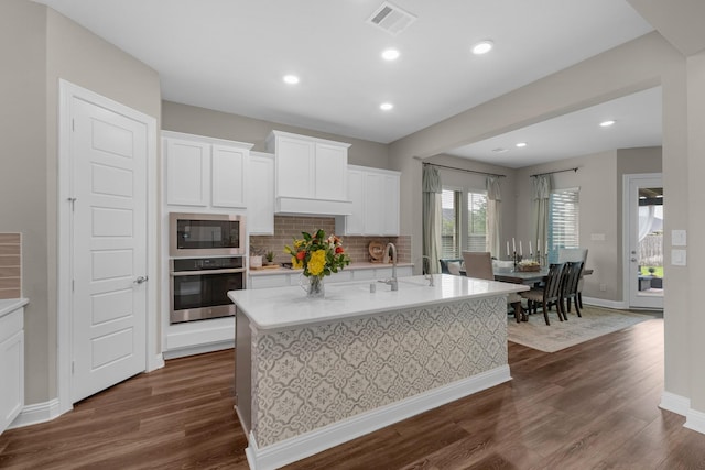 1926 Kingston Meadow Ln, Katy, TX 77494 - kitchen featuring stainless steel oven, built in microwave, dark wood-style flooring, light countertops, and recessed lighting
