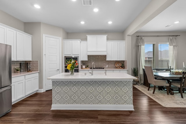1926 Kingston Meadow Ln, Katy, TX 77494 - kitchen with stainless steel appliances, light countertops, tasteful backsplash, white cabinetry, and recessed lighting