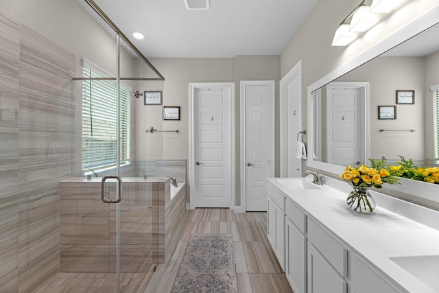 1926 Kingston Meadow Ln, Katy, TX 77494 - bathroom featuring double vanity, a stall shower, and a garden tub