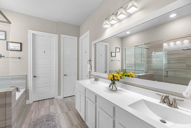 1926 Kingston Meadow Ln, Katy, TX 77494 - bathroom featuring a stall shower, double vanity, a garden tub, and recessed lighting