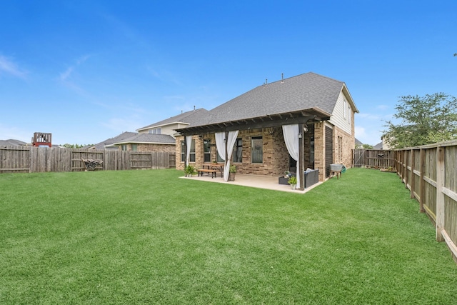 1926 Kingston Meadow Ln, Katy, TX 77494 - rear view of property with brick siding, a fenced backyard, a patio area, and roof with shingles