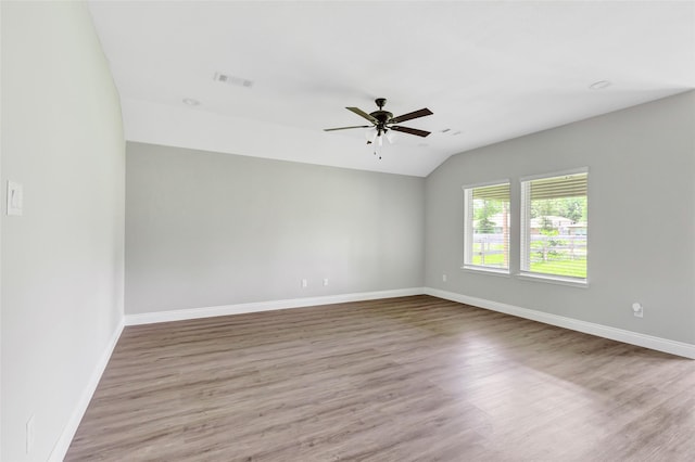 214 Kickapoo Dr, Anahuac, TX 77514 - unfurnished room with vaulted ceiling, a ceiling fan, and wood finished floors