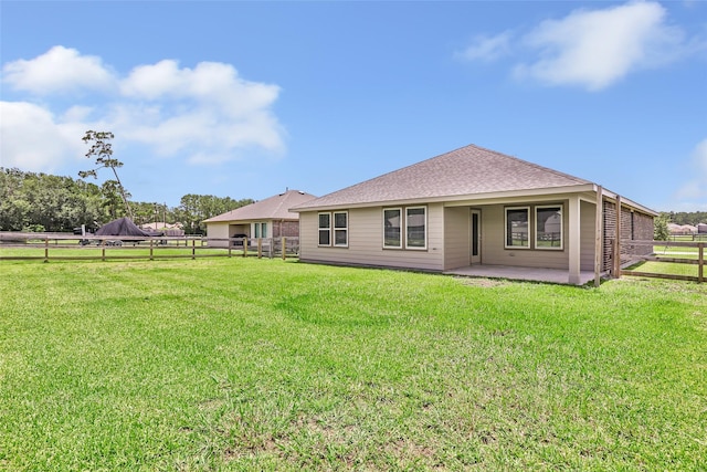 214 Kickapoo Dr, Anahuac, TX 77514 - rear view of property with a patio area, a fenced backyard, and roof with shingles