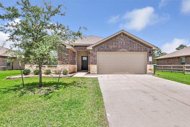 214 Kickapoo Dr, Anahuac, TX 77514 - single story home featuring brick siding, a garage, stone siding, and driveway