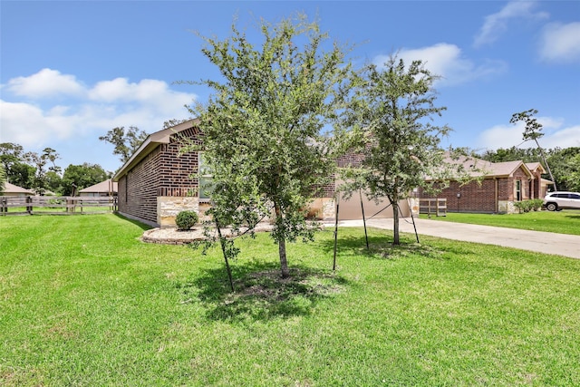 214 Kickapoo Dr, Anahuac, TX 77514 - view of yard featuring concrete driveway