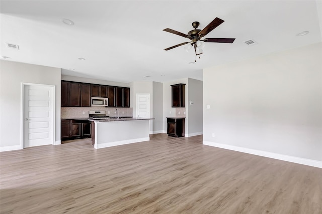 214 Kickapoo Dr, Anahuac, TX 77514 - unfurnished living room with light wood-style floors and a ceiling fan