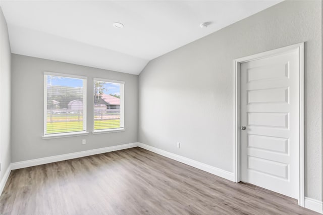 214 Kickapoo Dr, Anahuac, TX 77514 - spare room featuring lofted ceiling and wood finished floors