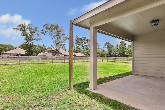 214 Kickapoo Dr, Anahuac, TX 77514 - view of yard featuring a patio area and a rural view